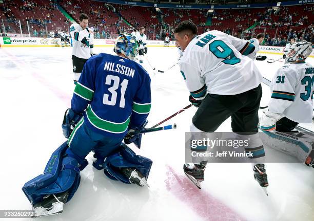 Evander Kane of the San Jose Sharks talks with Anders Nilsson of the Vancouver Canucks before their NHL game at Rogers Arena March 17, 2018 in...