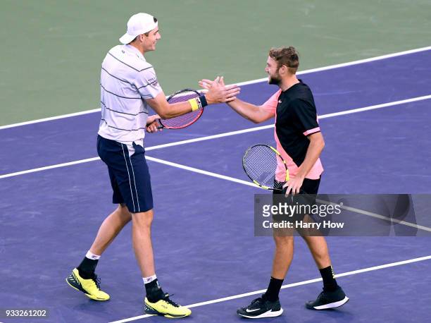 John Isner and Jack Sock of the United States celebrate their ATP doubles final win over Bob Bryan and Mike Bryan of the United States during the BNP...