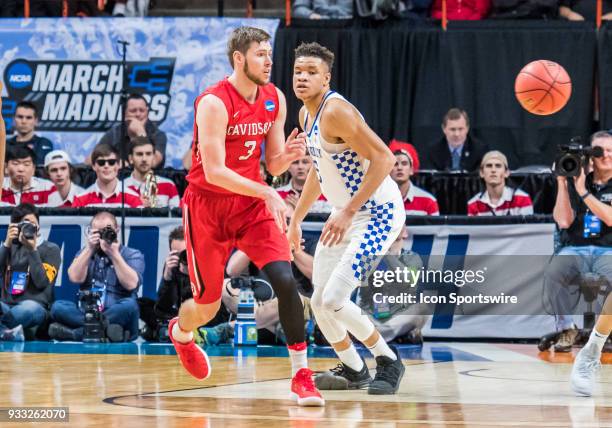 Jordan Watkins of the Davidson Wildcats passes around F Kevin Knox of the Kentucky Wildcats during the NCAA Division I Men's Championship First Round...