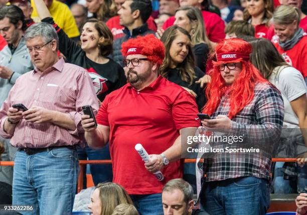 Davidson Wildcats fans watching the game on their mobile devices during the NCAA Division I Men's Championship First Round game between the Kentucky...