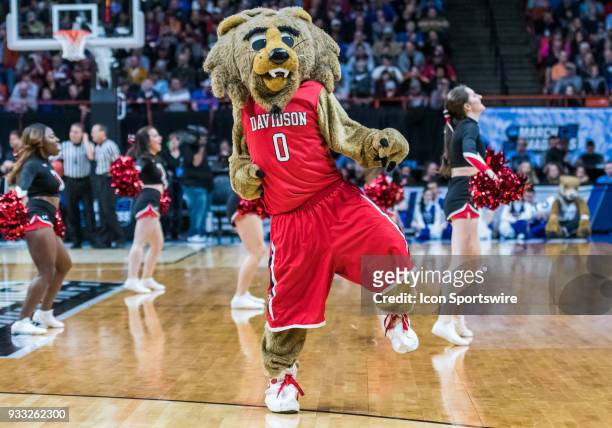The Davidson Wildcats mascot performs with the cheerleaders during the NCAA Division I Men's Championship First Round game between the Kentucky...