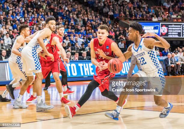 Shai Gilgeous-Alexander of the Kentucky Wildcats gets a hand on the ball from G Kellan Grady of the Davidson Wildcats during the NCAA Division I...