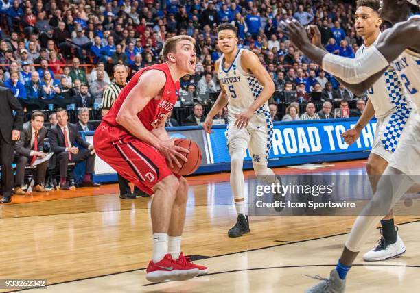 Peyton Aldridge of the Davidson Wildcats stops as Kentucky Wildcats defenders rush in to block his shot during the NCAA Division I Men's Championship...