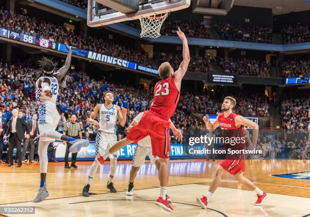 Peyton Aldridge of the Davidson Wildcats does a reverse lay up under the basket during the NCAA Division I Men's Championship First Round game...