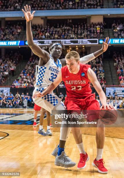 Wenyen Gabriel of the Kentucky Wildcats puts up a block on F Peyton Aldridge of the Davidson Wildcats during the NCAA Division I Men's Championship...