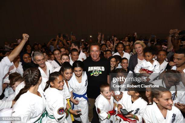 Arnold Schwarzenegger poses with martial art athletes during the Arnold Sports Festival Australia at The Melbourne Convention and Exhibition Centre...