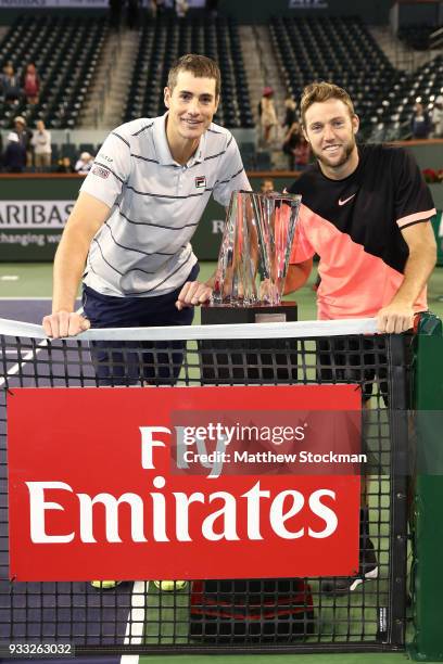 John Isner and Jack Sock pose with the winner's trophy after defeating Mike Bryan and Bob Bryan during the men's doubles final on Day 13 of the BNP...