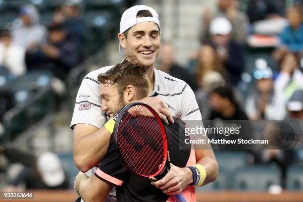 John Isner and Jack Sock celebrate match point aganst Mike Bryan and Bob Bryan during the men's doubles final on Day 13 of the BNP Paribas Open at...
