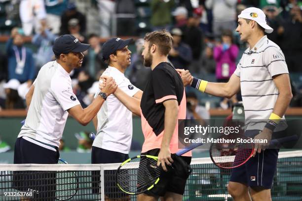 Bob Bryan and Mike Bryan congratulate Jack Sock and John Isner after their match during the men's doubles final on Day 13 of the BNP Paribas Open at...