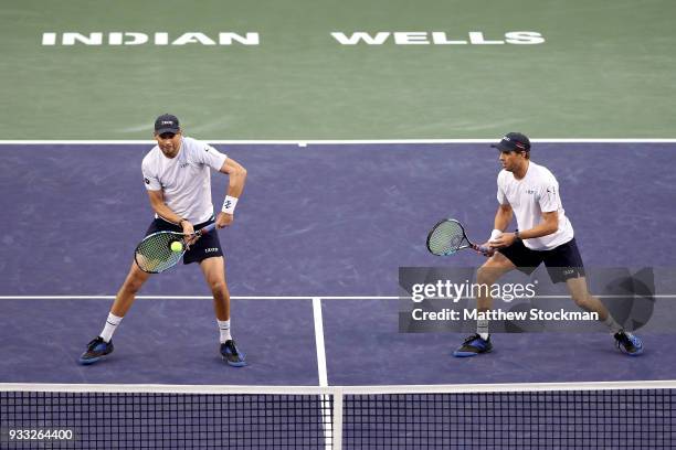 Bob Bryan returns a shot to John Isner and Jack Sock while playing with Mike Bryan during the men's doubles final on Day 13 of the BNP Paribas Open...