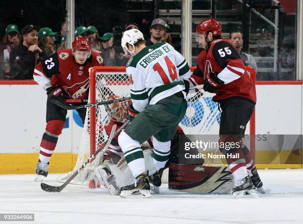 Goalie Antti Raanta of the Arizona Coyotes covers the puck in front of Joel Eriksson Ek of the Minnesota Wild as Oliver Ekman-Larsson and Jason...