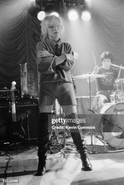 Singer Debbie Harry of American band Blondie, wearing shorts and thigh high boots, and drummer Clem Burke perform on stage at King George's Hall in...