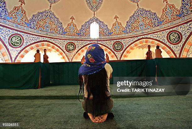 An Alevi woman prays in the women's part of the mosque in Hacibektash, 15 August 2005. The hamlet was named after Haci Bektas Veli, who lived between...