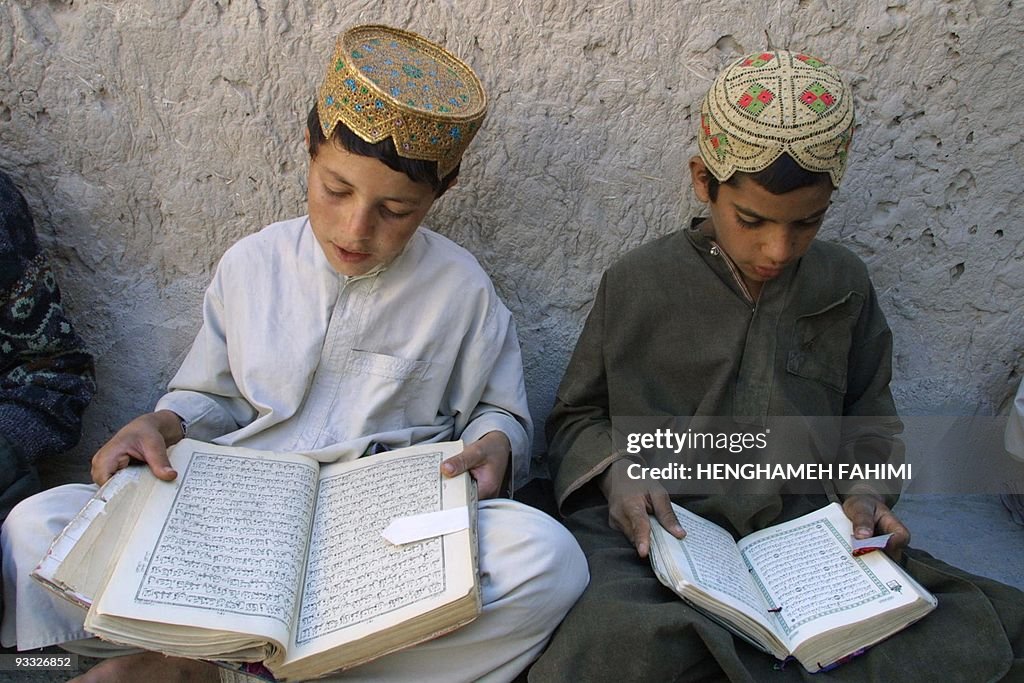 Afghan refugee boys read Islam's holy bo
