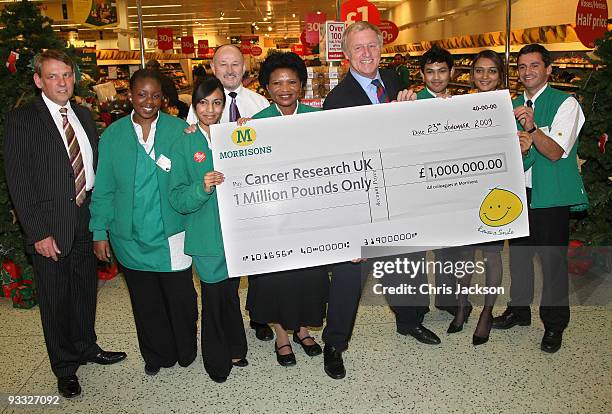 Presenter Chris Tarrant holds a Million Pound cheque on behalf of Cancer Research UK, at Camden Morrisons on November 23, 2009 in London, England....