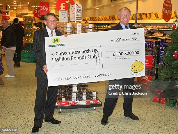 Presenter Chris Tarrant holds a Million Pound cheque on behalf of Cancer Research UK, at Camden Morrisons on November 23, 2009 in London, England....