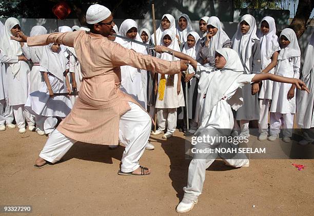 Indian Muslim schoolgirls are given martial arts training by instructor Mohammad Abdul Rehaman during a demonstration at St. Maaz High School in...