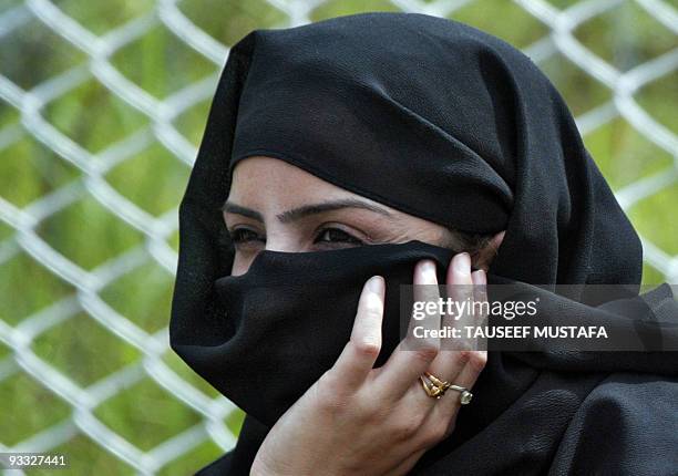 Jammu and Kashmir Police police woman covers herself with a veil after taking part in the official celebrations for India's Independence Day at...