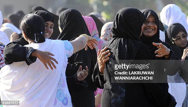 Sri Lankan Muslim women exchange Eid greetings after offering Eid al-Fitr prayers at a mosque in Colombo on October 1, 2008. Muslims around the world...