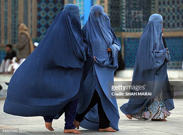 Burqa-clad women walk at the Hazrat Ali Shrine in the northern town of Mazar-i-Sharif in Balkh province on March 19, 2009. Tens of thousands of...
