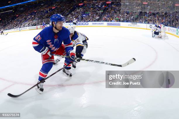 David Desharnais of the New York Rangers is pressured by Chris Thorburn of the St. Louis Blues at Scottrade Center on March 17, 2018 in St. Louis,...