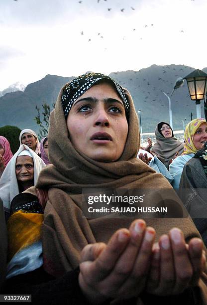 Kashmiri Muslim devotees pray as a cleric displays a relic of Prophet Mohammad to mark his birthday at Srinagar's Hazratbal shrine, early 11 April...