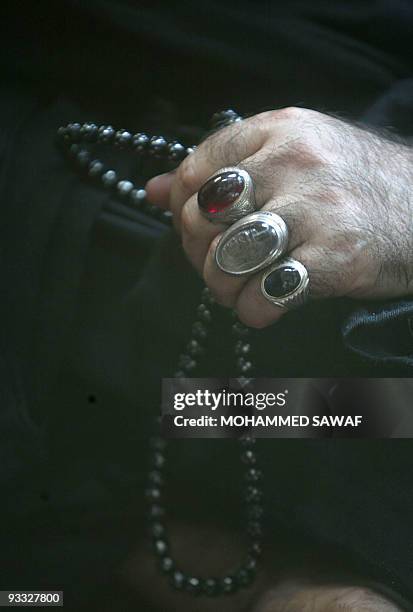 Shiite Muslim holds his prayer beads as he takes part in the Friday noon prayers in the southern holy city of Karbala, some 120 kilometers form...