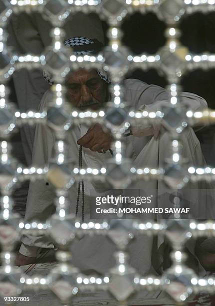 Shiite Muslim holds his prayer beads as he takes part in the Friday noon prayers in the southern holy city of Karbala, some 120 kilometers form...