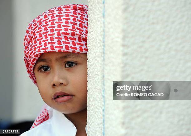 Three-year-old Filipino Muslim, Michael Muksan attends mid-morning prayer and the muezzin's call at Manila's Blue Mosque on August 29, 2008. It is...