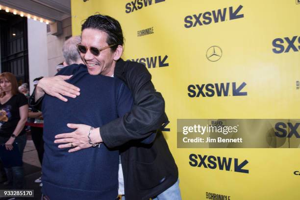 Actor Bob Balaban hugs actor Konichi Nomura on the red carpet at the North American premiere of the film "Isle of Dogs" to close the SXSW Film...