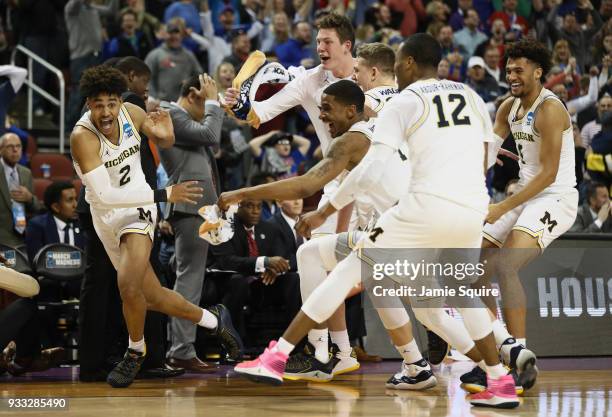 Jordan Poole of the Michigan Wolverines celebrates his 3-point buzzer beater for a 64-63 win over the Houston Cougars during the second round of the...