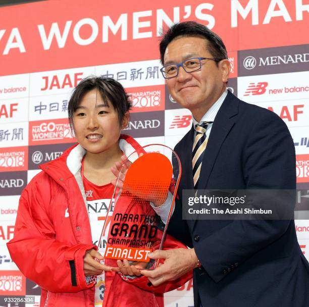 Hanami Sekine of Japan is congratulated by Toshihiko Seko after her third finish after the Nagoya Women's Marathon 2018 at Nagoya Dome on March 11,...