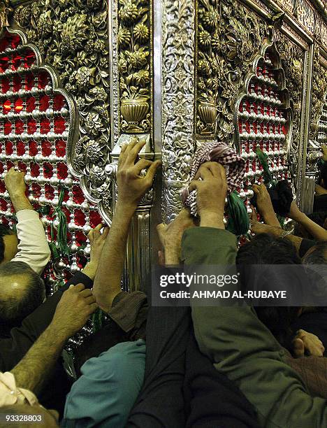 Muslim Shiites pray over the tomb of Imam Abbas bin Ali bin Abi Taleb in the shrine city of Karbala, some 100 km south of Baghdad, early 06 March...