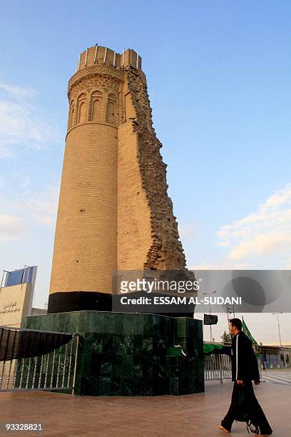 An Iraqi walks past the minaret of Shiite Imam Ali's historical mosque in the southern Iraqi city of Basra, late 20 February 2007. The mosque which...