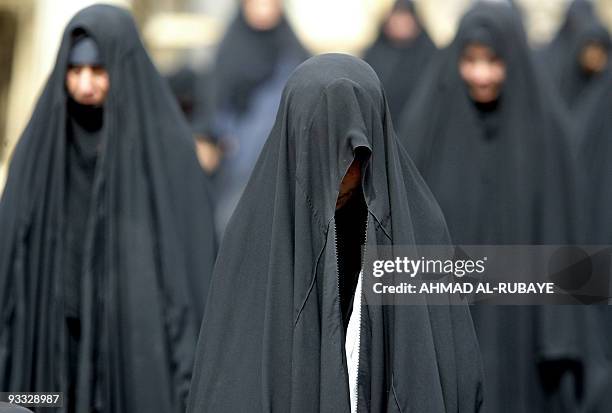 Shiite Muslim Iraqi women perform along with thousands of worshippers the Friday noon prayer at the mosque of Kufa, near the holy city of Najaf, 160...