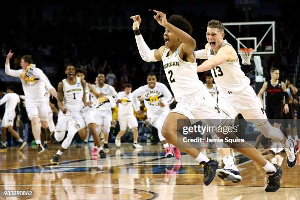 Jordan Poole and Moritz Wagner of the Michigan Wolverines celebrate Poole's 3-point buzzer beater for a 64-63 win over the Houston Cougars during the...