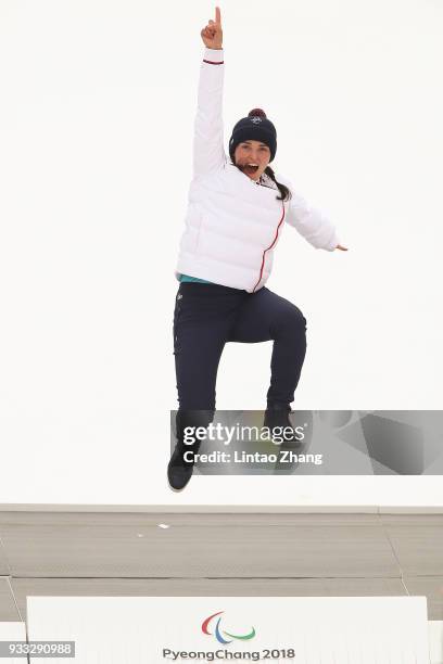 Gold medallist Marie Bochet of France celebrates on the podium during the medal ceremony for the Alpine Skiing- Women's Slalom Standing Run 2 during...