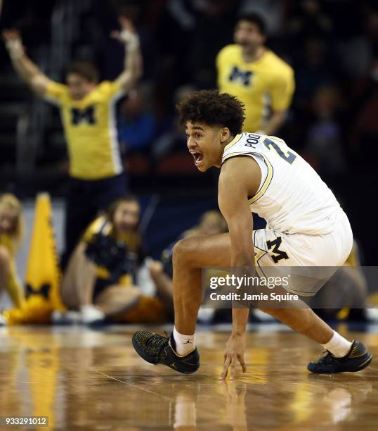 Jordan Poole of the Michigan Wolverines celebrates his 3-point buzzer beater for a 64-63 win over the Houston Cougars during the second round of the...