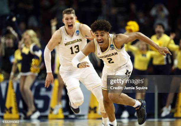 Jordan Poole and Moritz Wagner of the Michigan Wolverines celebrate Poole's 3-point buzzer beater for a 64-63 win over the Houston Cougars during the...