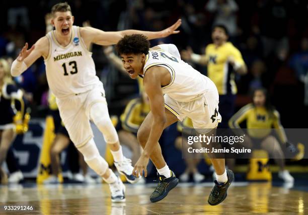 Jordan Poole and Moritz Wagner of the Michigan Wolverines celebrate Poole's 3-point buzzer beater for a 64-63 win over the Houston Cougars during the...
