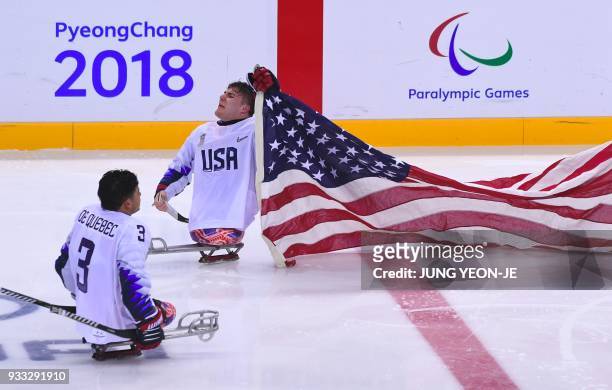 Players celebrate their victory after the ice hockey gold medal game between Canada and the US at the Gangneung Hockey Centre during the Pyeongchang...