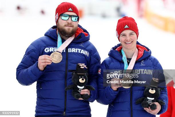 Millie Knight of Great Britain, right, and her guide Brett Wild celebrate with their bronze medals in the Women's Visually Impaired Slalom at...