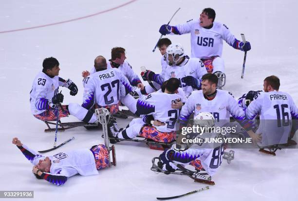 Players celebrate their victory after the ice hockey gold medal game between Canada and the US at the Gangneung Hockey Centre during the Pyeongchang...