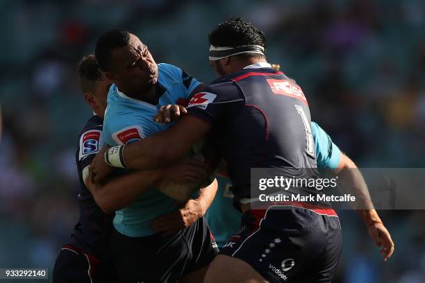 Kurtley Beale of the Waratahs is tackled during the round five Super Rugby match between the Waratahs and the Rebels at Allianz Stadium on March 18,...
