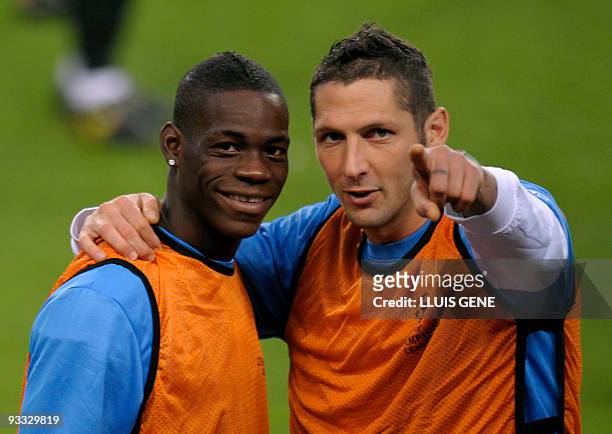 Mario Balotelli and Marco Materazzi of Inter Milan joke during a training session at the Camp Nou stadium in Barcelona, on November 23, 2009 on the...