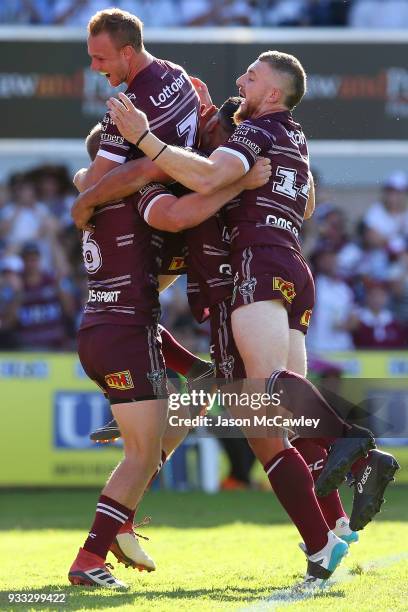 Lachlan Croker of the Sea Eagles celebrates with team mates after scoring a tryduring the round two NRL match between the Manly Sea Eagles and the...