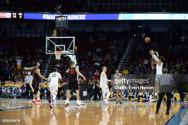 Jordan Poole of the Michigan Wolverines shoots the game winning shot against the Houston Cougars in the second round of the 2018 NCAA Photos via...