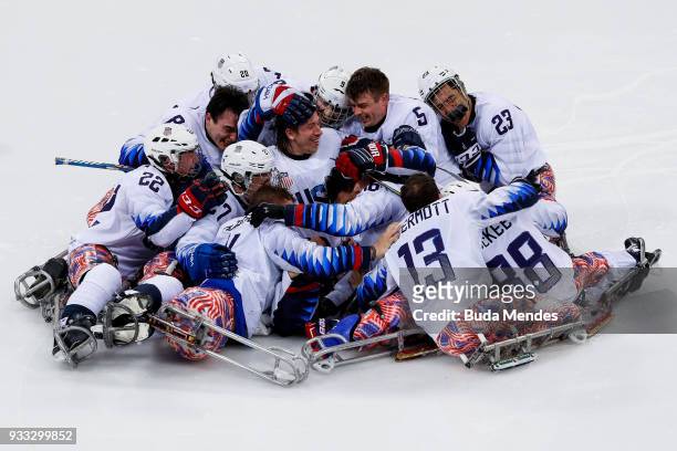 Team of the United States celebrates the gold medal after winning in the Ice Hockey gold medal game between United States and Canada during day nine...
