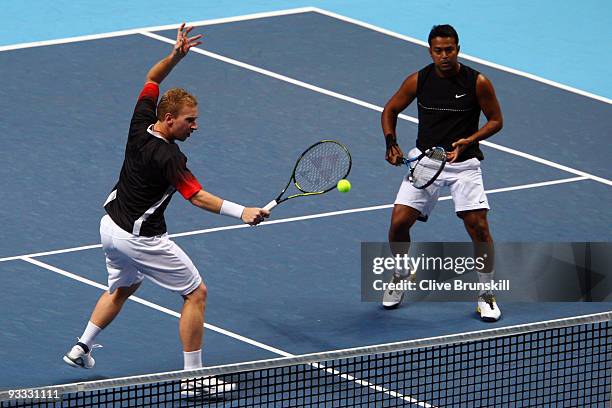 Lukas Dlouhy of Czech Republic returns the ball playing with Leander Paes of India during the men's doubles first round match against Lukasz Kubot of...