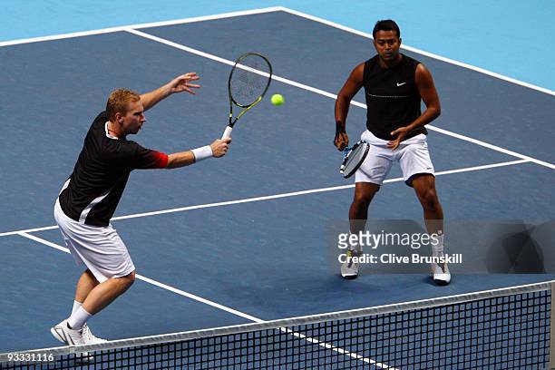 Lukas Dlouhy of Czech Republic returns the ball playing with Leander Paes of India during the men's doubles first round match against Lukasz Kubot of...